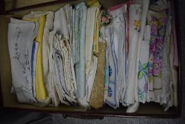 A suitcase of mixed vintage and antique table linen, including embroidered items, lace and