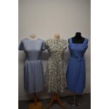 Three vintage 1950s and 1960s dresses, including abstract floral dress, medium sizes.