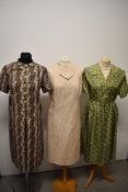 Three vintage dresses, comprising; sage green dress with pleated skirt circa 50s/60s, and two