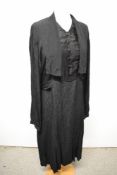 A 1930s black textured crepe day dress, having draped collar, integrated modesty panel, full