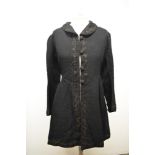 A Victorian black wool coat, having silk lining, silk collar, braided detailing, two vents to the