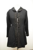 A Victorian black wool coat, having silk lining, silk collar, braided detailing, two vents to the