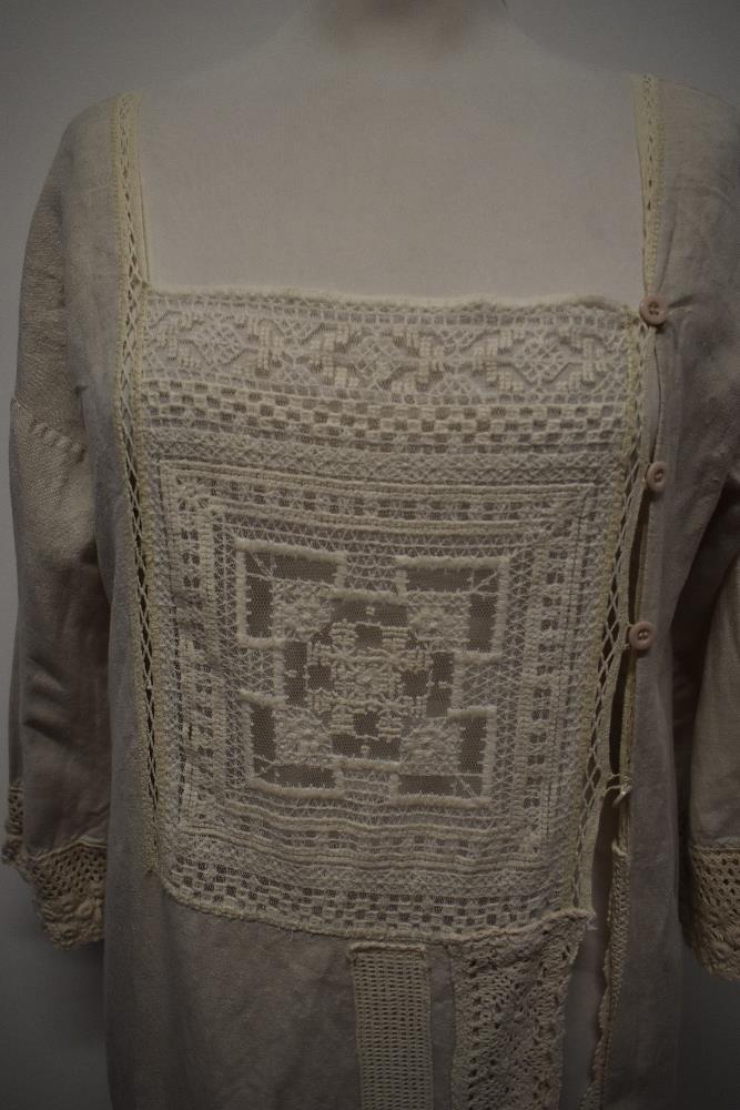 An interesting early 20th century linen smock/ over dress, having embroidered tulle panel to - Image 3 of 12