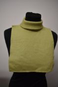 A 1960s green knitted modesty panel with roll neck.