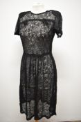 An early 1940s sheer black lace day dress, having bow detail to bust, side press stud fastening