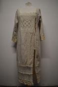 An interesting early 20th century linen smock/ over dress, having embroidered tulle panel to