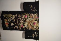 An amazing early 20th century extensively embroidered kimono dressing gown, having black silk ground