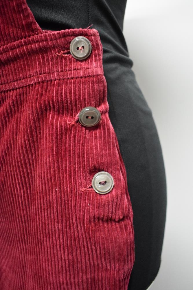 A pair of Circa mid century vibrant cherry red corduroy dungarees, having side button fastening, - Image 2 of 7