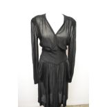A late 1930s/early 40s semi sheer black day dress, having peplum detail to pointed dropped