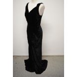An Art Deco 1930s black velvet bias cut evening gown, having low cross over plunging neckline.