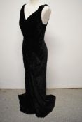 An Art Deco 1930s black velvet bias cut evening gown, having low cross over plunging neckline.