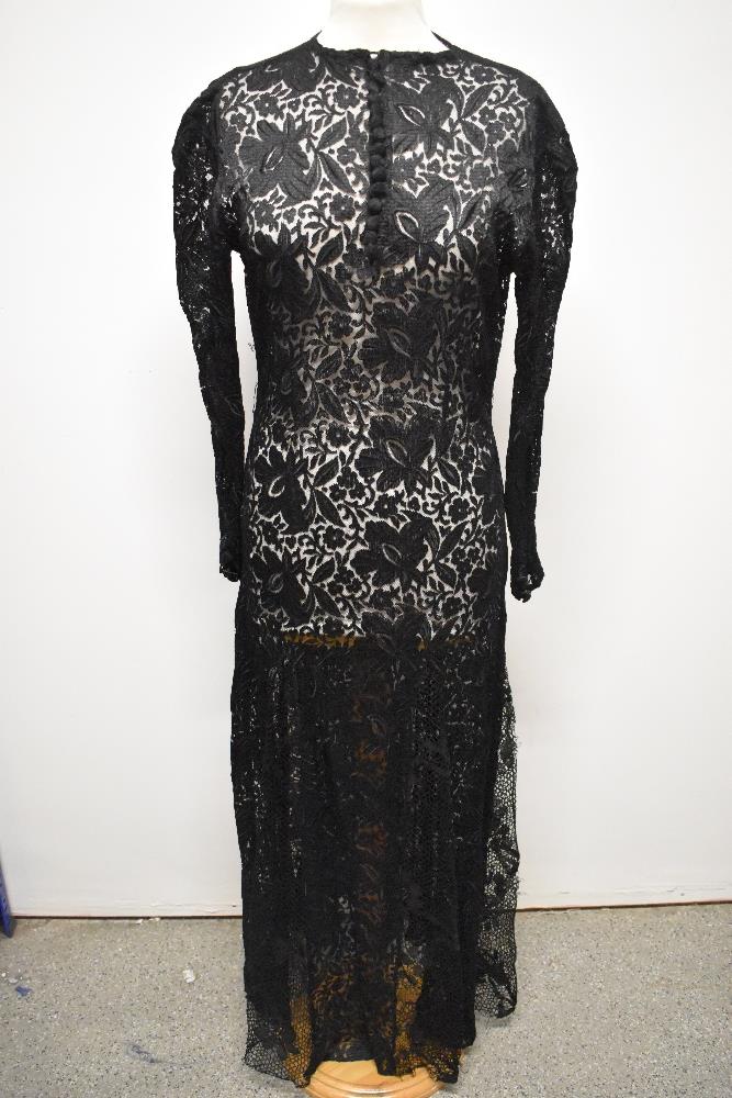 A 1930s bias cut lace evening dress, having button down front, round collar and long sleeves with