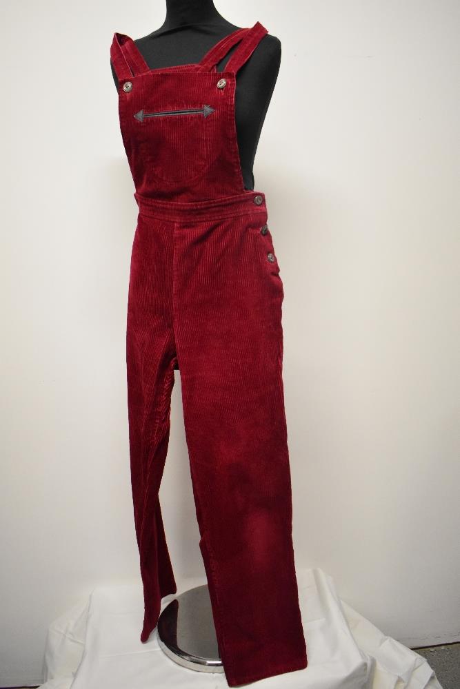 A pair of Circa mid century vibrant cherry red corduroy dungarees, having side button fastening,