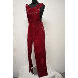 A pair of Circa mid century vibrant cherry red corduroy dungarees, having side button fastening,