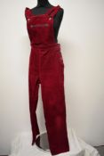 A pair of Circa mid century vibrant cherry red corduroy dungarees, having side button fastening,