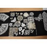 A collection of intricate hand worked lace, including butterflies, leaves, flowers and a mouse etc.