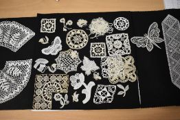 A collection of intricate hand worked lace, including butterflies, leaves, flowers and a mouse etc.