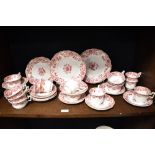 A Victorian porcelain part tea service on white ground and decorated with repeating floral motifs