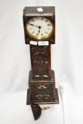 A 20th century gothic styled mantel clock in the form of a grandfather clock having extensive carved