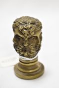 A cast brass desk seal, having a multi-faceted six face Classical design, and measuring 6cm tall