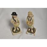 Two 19th century prattware figurines, depicting two cherubic children with baskets, possible