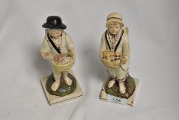 Two 19th century prattware figurines, depicting two cherubic children with baskets, possible