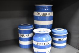 A group of four TG Green Cornish Ware storage jars, to comprise three lidded Lentils, Raisins, and