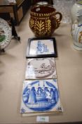 Three 18th/19th delft tiles, one framed and sold along with a large two-handled slipware mug, marked