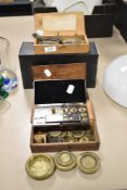 A variety of vintage and antique weights and two sets of scales.
