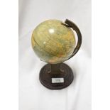 A small vintage tin globe, of traditional arrangement, on a grained tin circular base