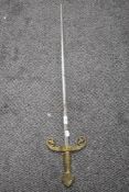 A 20th century ceremonial sword, with cast brass guard, grip and pommel, the blade with moulded
