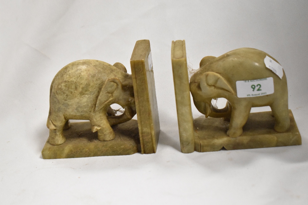 A pair of soap stone carved elephant book ends, measuring 10cm high