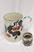 A Scottish Wemyss Pottery Cherries tankard, 15cm tall, and a similar crackle glazed thistle jar, 6cm