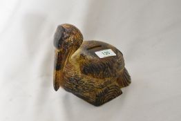 A vintage ceramic money box in the form of a Pelican.