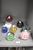 An assorted collection of art glass paperweights, to include a teapot form paperweight and a