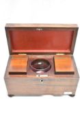 An early 19th Century mahogany tea caddy, having a fitted interior with glass mixing bowl, and