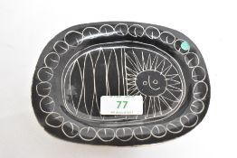 A Jacques Pouchain ceramic dish, decorated with a Picassso style illustration on black ground,