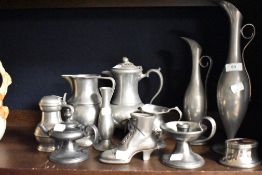 A pair of Etain Pur pewter ewers, an Edwin Blyde claret jug, a novelty pewter boot vase, and other