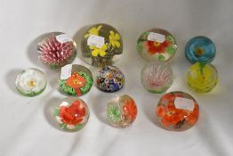 A collection of vintage floral paperweights and one Milliefiori.