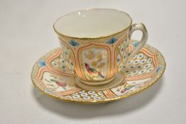 A mid-19th Century porcelain teacup and saucer, decorated with vignettes of exotic birds, the saucer