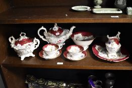 A small quantity of 19th Century tableware on red and white ground, decorated with floral sprays and