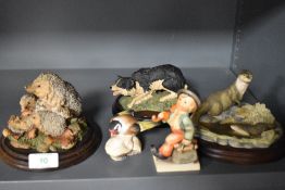 Three mounted models of animals, by Royal Doulton and Border Fine Arts, and to include a hedgehog