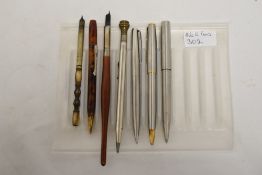 A selection of writing instruments including two dipping pens, an Eversharp propelling pencil and