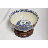 A 20th Century Chinese blue and white footed bowl, decorated with panels of figures and foliage,