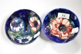 Two William Moorcroft footed bowls on blue ground, anemone patterned, and measuring 5.5cm tall