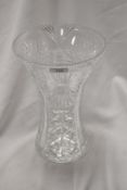 A large cut-crystal vase, of flared cylindrical form with stylised foliate and repeating designs