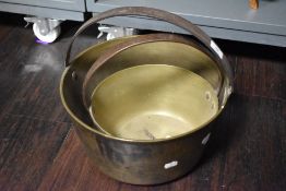 Two 19th Century brass preserve pans with cast iron carrying handles, the largest measuring 35cm