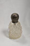 A Victorian cut glass and silver lidded scent bottle, with rubbed hallmarks