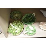 A small group of naturalistically moulded cabbage leaf design items, plates, dish and sauce tureen