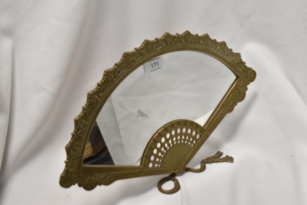 A cast-brass dressing table mirror, modelled as an opened fan, with easel type stand to reverse